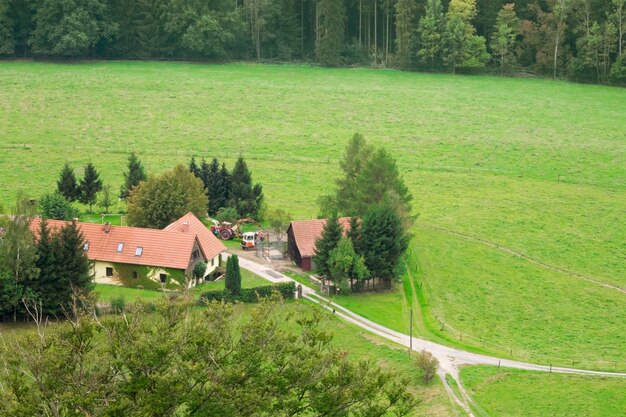 Country house on a background of the forest and green fields View from above