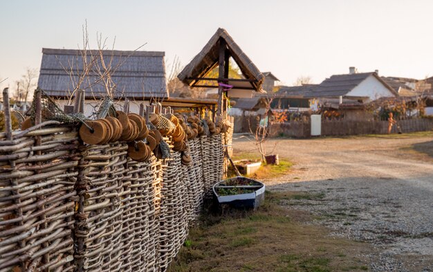 Country landscape. Wicker fence in the foreground.