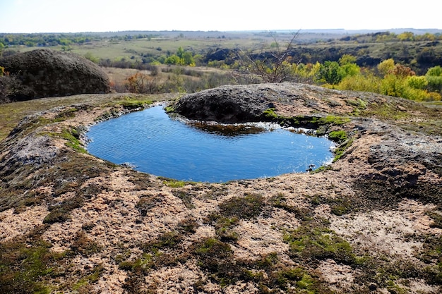 Country landscape with small pool and hills