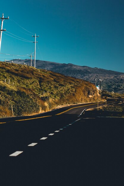 Country road against clear blue sky