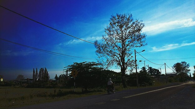 Country road against cloudy sky