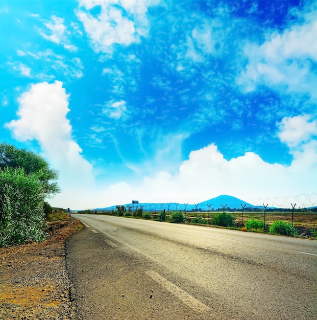 Country road under cloudy sky