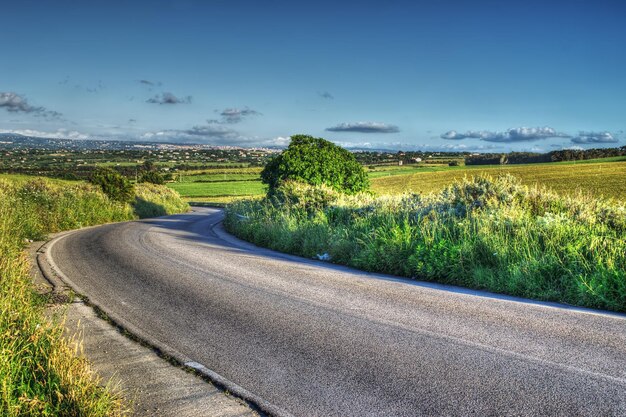 Country road in a green hill Processed for hdr tone mapping effect