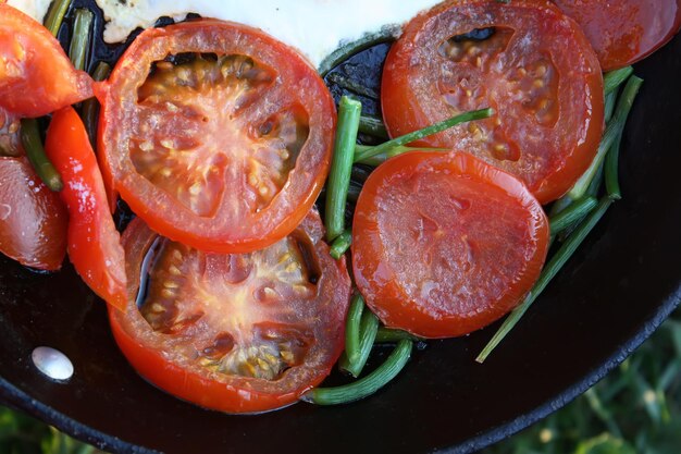 Country style fried eggs with fresh red tomatoes