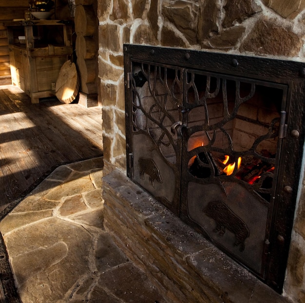 Photo country style interior in hunter chalet with fireplace