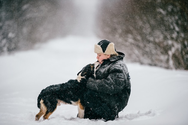 Photo country woman. adult female walking the dog. funny winter girl lifestyle outdoor portrait.