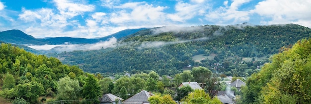 朝の霧のパノラマの山々 を背景に田舎