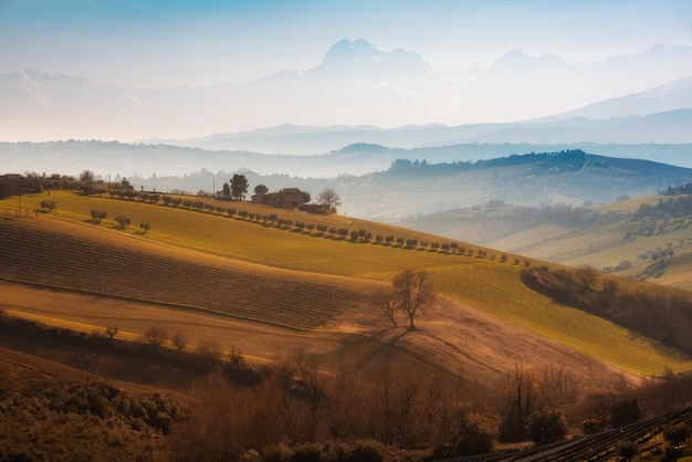 Countryside landscape in autumn agricultural fields among hills