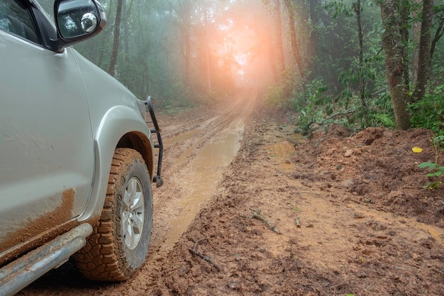 Countryside landscape with car on muddy road