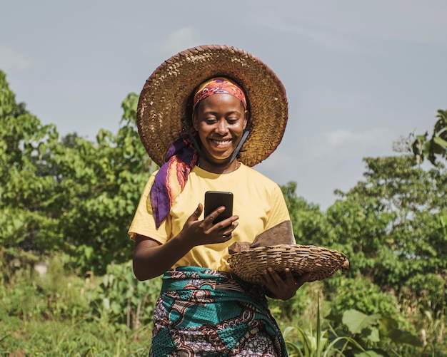 Foto donna di campagna che controlla il suo telefono