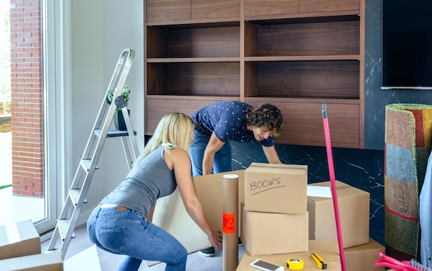 Photo couple adjusting box at home