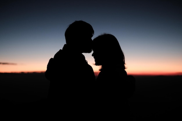 A couple are kissing on the peak