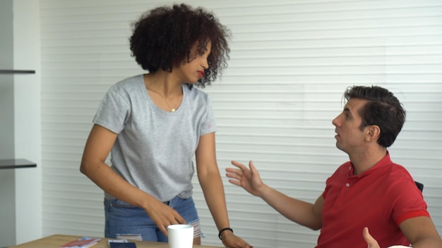 Photo couple arguing against wall at home