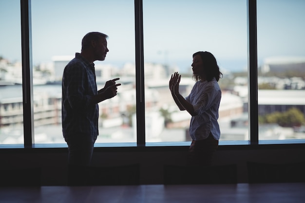 Couple arguing near the window