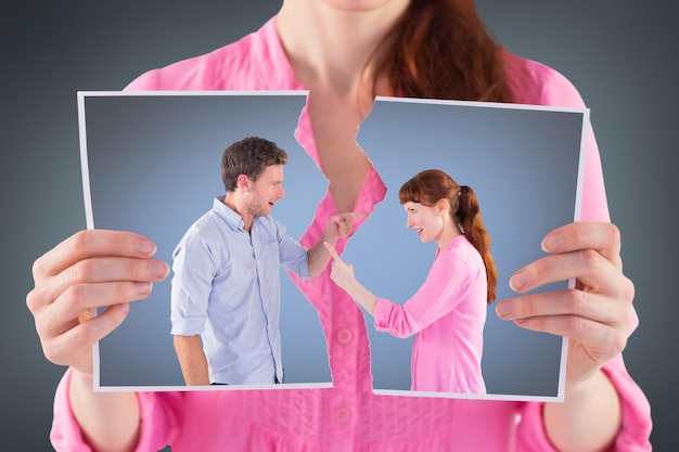 Couple arguing with each other against grey vignette