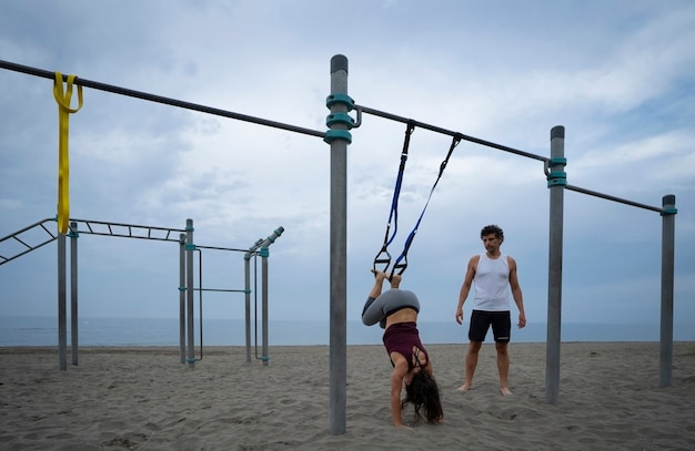 couple of athletes exercising on the beach