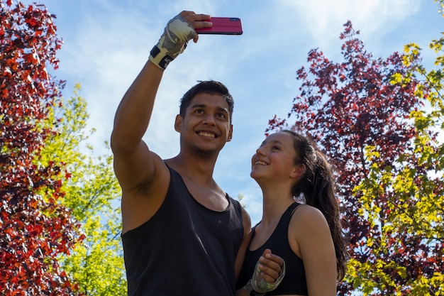 Couple of athletes taking a selfie during outdoor training