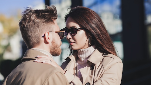 Couple in autumn coat loving each other outdoors