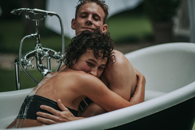 Couple in bathtub outdoors