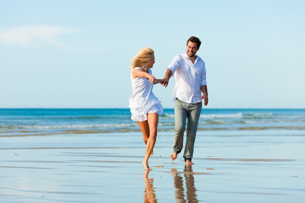 Couple on the beach running into glorious future