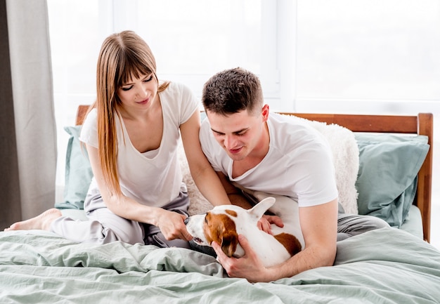 Couple in the bed with dog