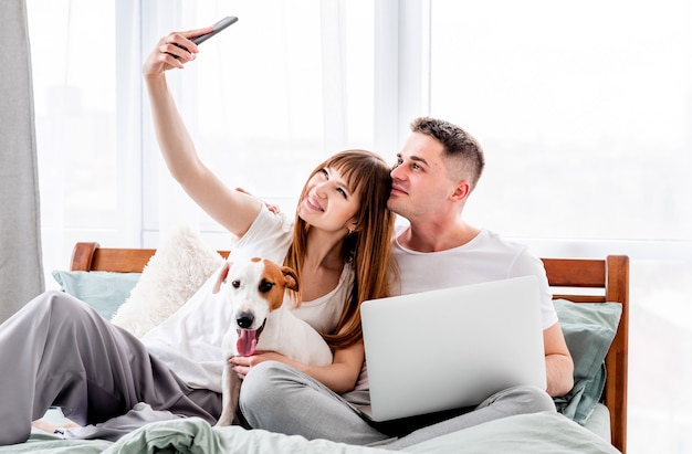 Couple in the bed with gadgets