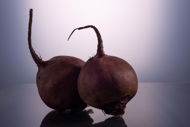 Couple beets on white background minimalistic still life