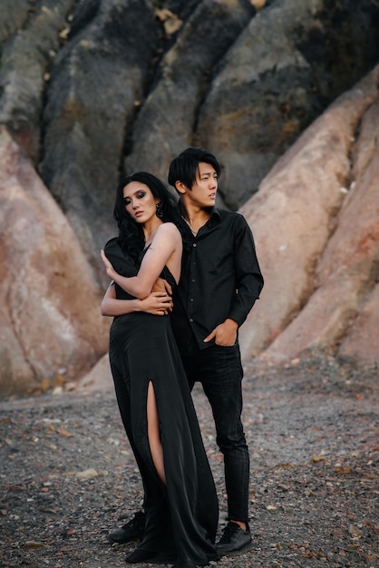 Couple in black clothes posing in nature