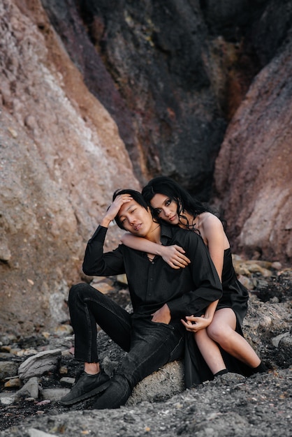 Couple in black clothes posing in nature