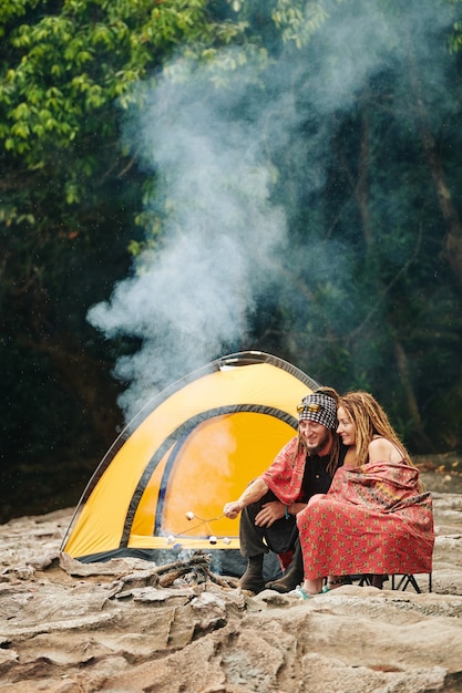 Couple in blanket making smores