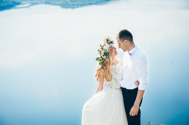 couple on blue sky background, water