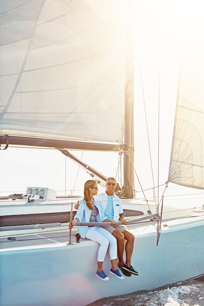 Couple boat and adventure at sea for holiday during summer to relax on luxury or rich cruise ocean vacation and people on yacht for outdoor travel and freedom to enjoy the sunshine together