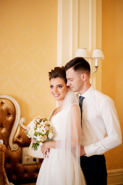 couple of bride and groom posing indoors