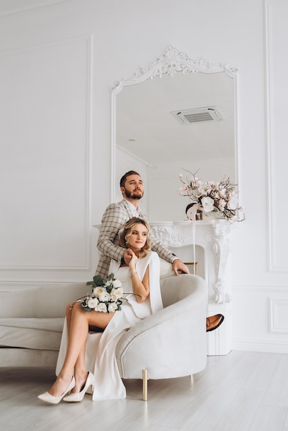 couple bride and groom on wedding day together in bright interior