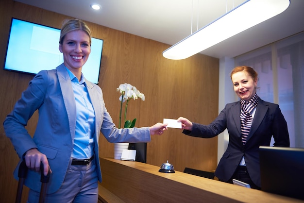 Couple on a business trip doing check-in at the hotel