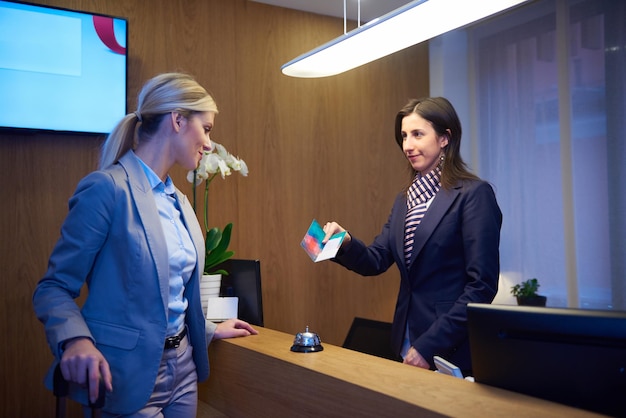 Couple on a business trip doing check-in at the hotel