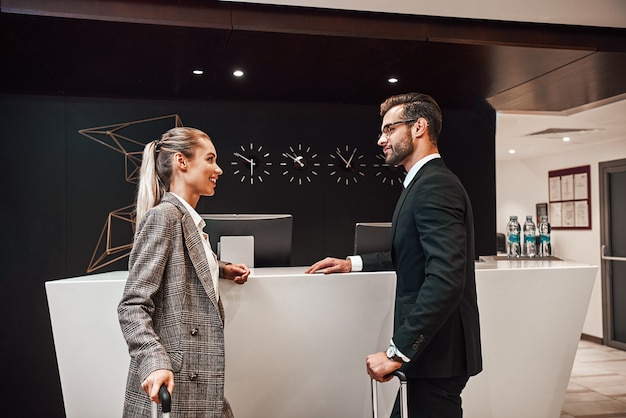 Couple on a business trip doing checkin at the hotel