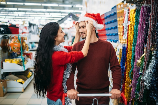Couple buying christmas decorations in store