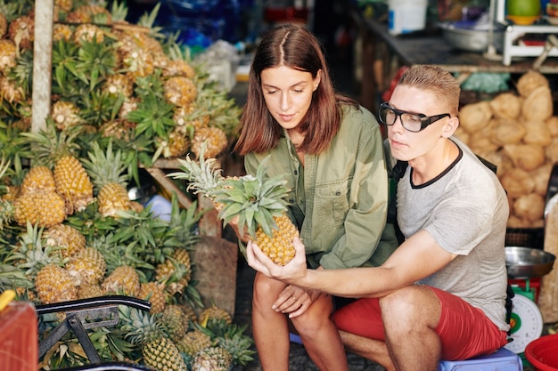 Couple buying pineapples