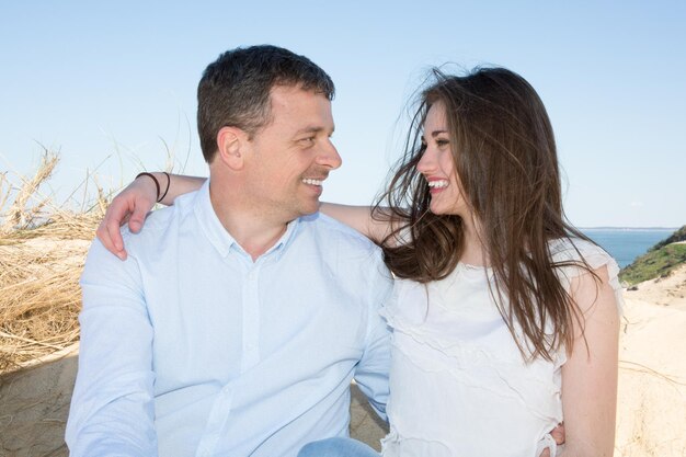 Couple by the sea looking at each other