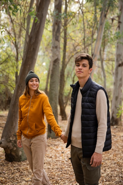 couple camping and walking in the woods