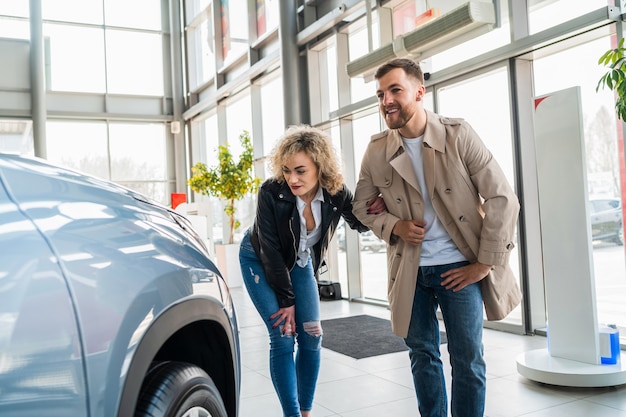 Couple in car dealership chooses car