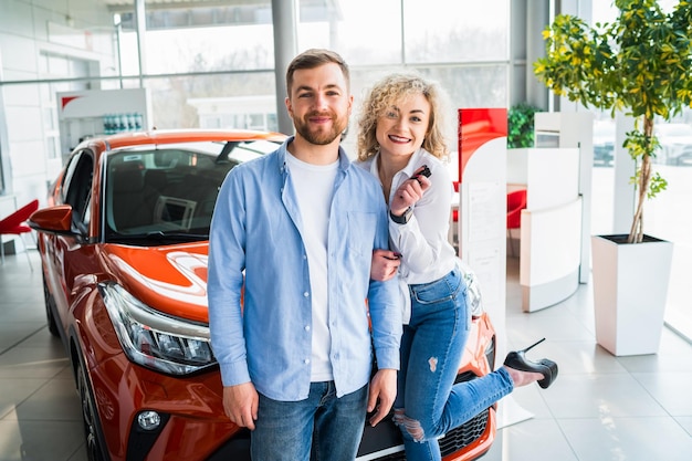 Couple in car dealership