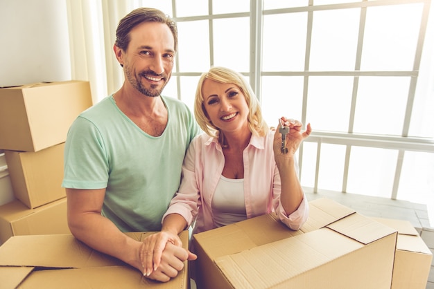 Couple in casual clothes is leaning on the boxes.