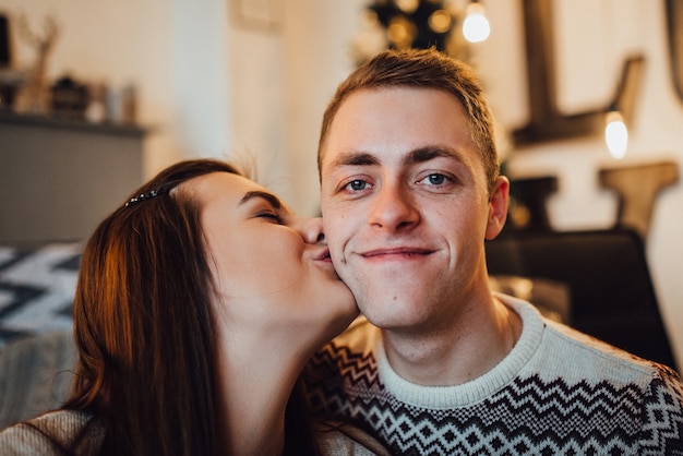 Couple celebrate Christmas in a warm atmosphere at home