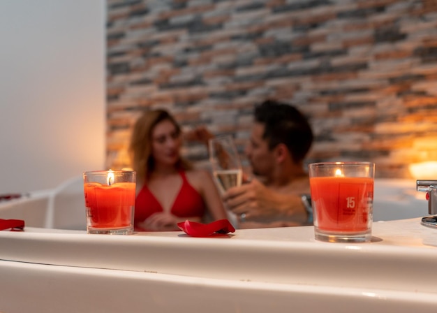 Couple celebrating a romantic evening for Valentine's Day in a hotel with a jacuzzi.