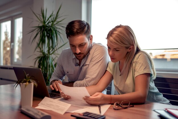 Couple checking their bills at home