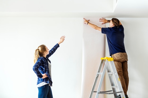 Couple choosing house wallpaper