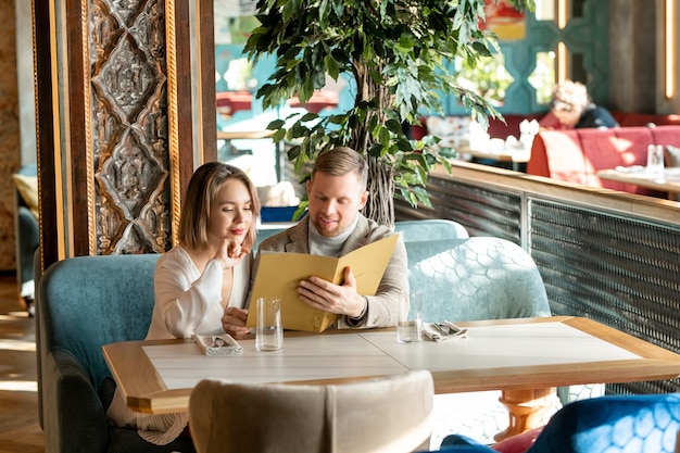 Couple Choosing Meal In Restaurant