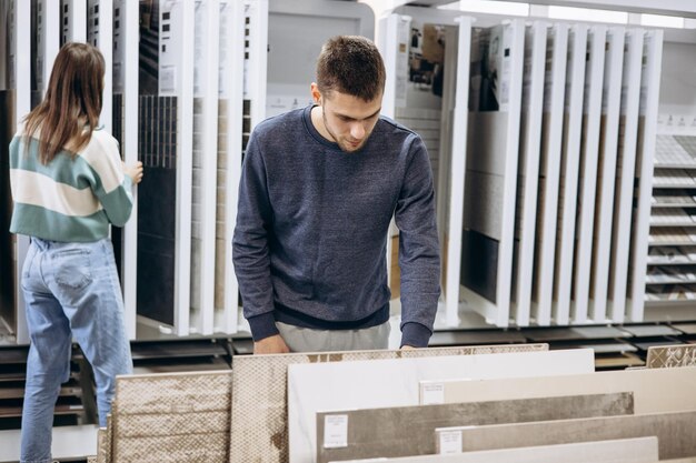 Couple choosing tiles at tiles storage